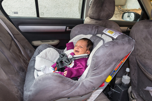 Infant baby boy on a infant car seat inside a car