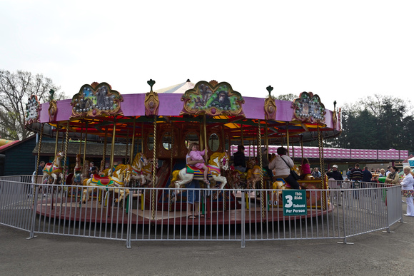 Children and adults at the Merry go round inside the Blair Drumm