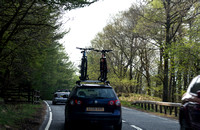 Car on a road in Scotland, with cycles mounted on the top