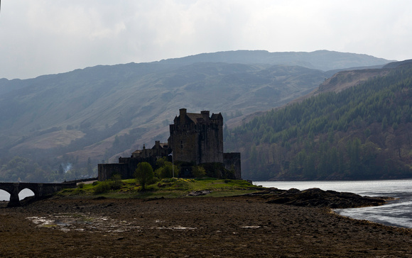 Flag of Scotland in front of the Eilean Donan Castle in the Scot