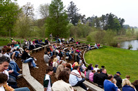People on wooden benches at the Birds of Prey show at the Blair