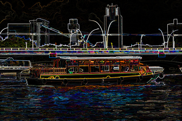 Colorful river cruise boat in Singapore next to a bridge