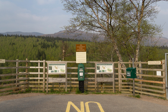Sign for the Corrieshalloch Gorge in Scotland with green open ar