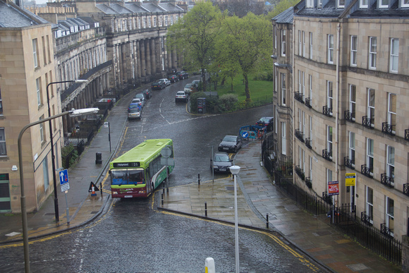 Bus moving on a wet path in Edinburgh