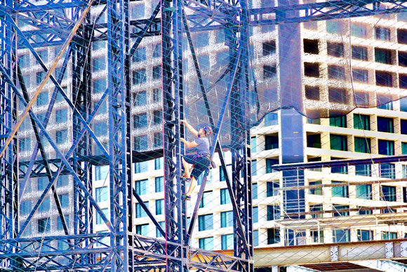 Man climbing a steel ladder in the Marina area in Singapore