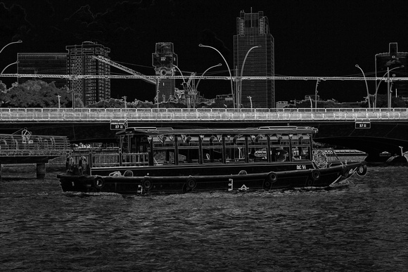 Colorful river cruise boat in Singapore next to a bridge