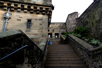 Grand staircase inside the Edinburgh Castle, with a sign for exh