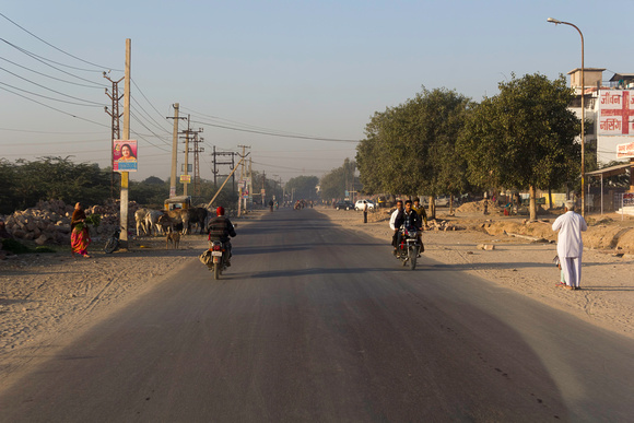 Motorbikes and cycles on an empty road in Jodhpur